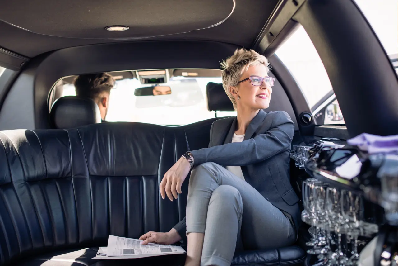 Person sitting in a luxurious car interior.