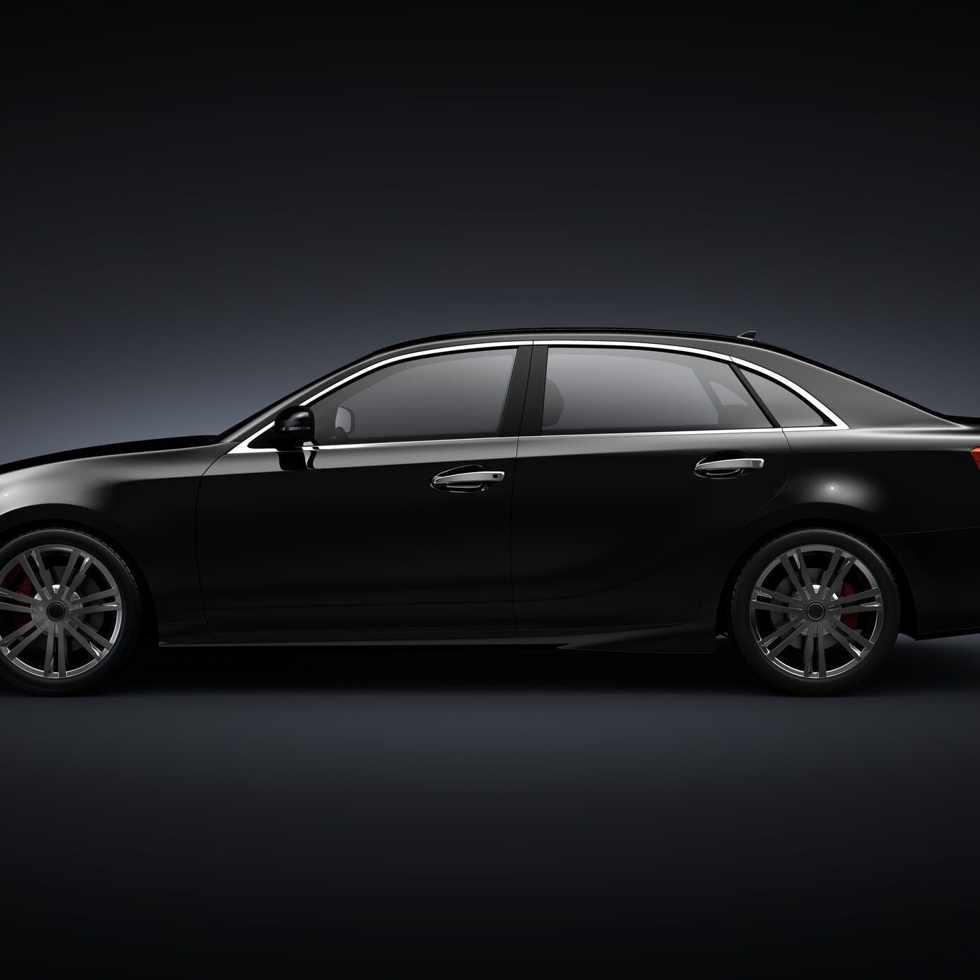 Sleek black sedan on dark background.