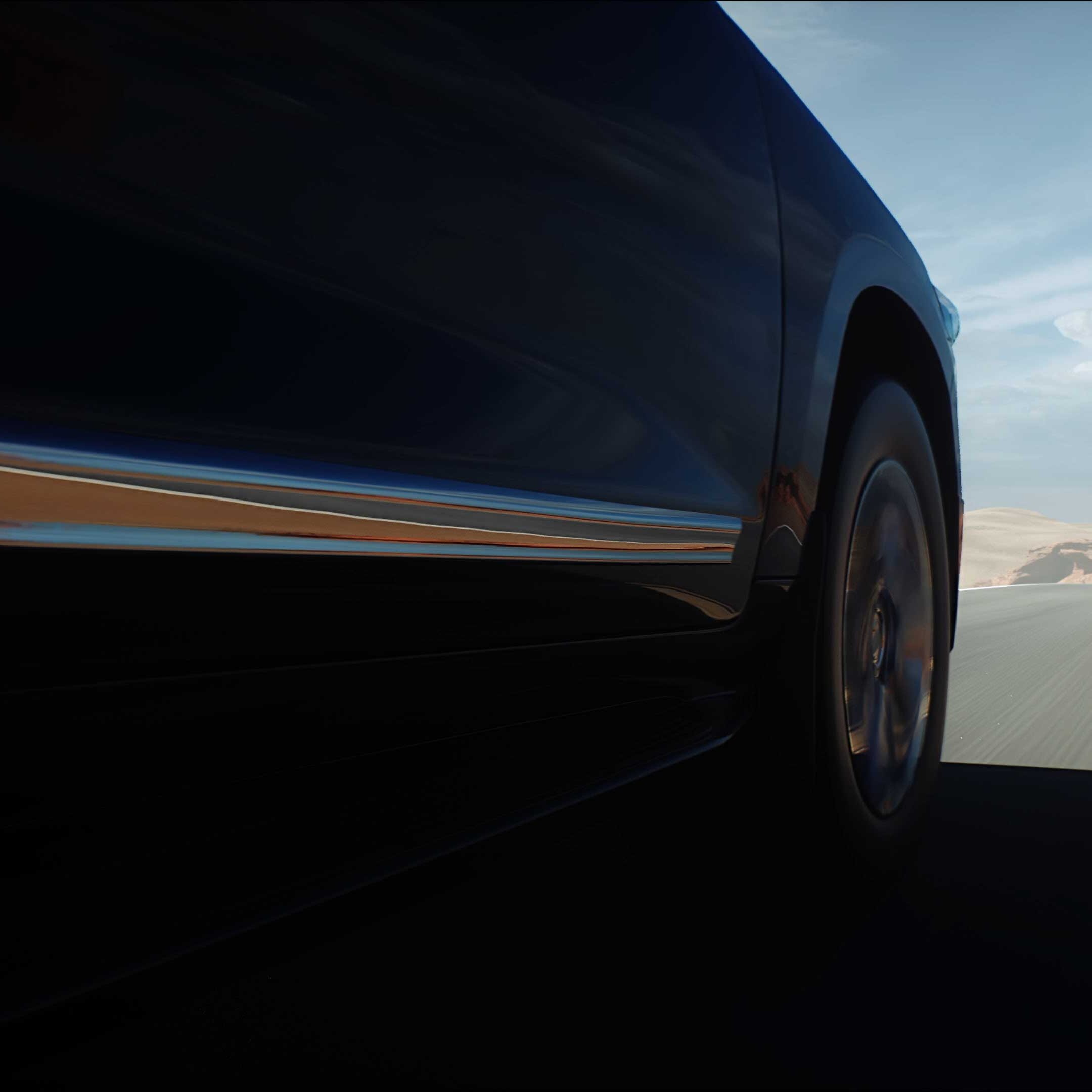Car driving on open desert road.